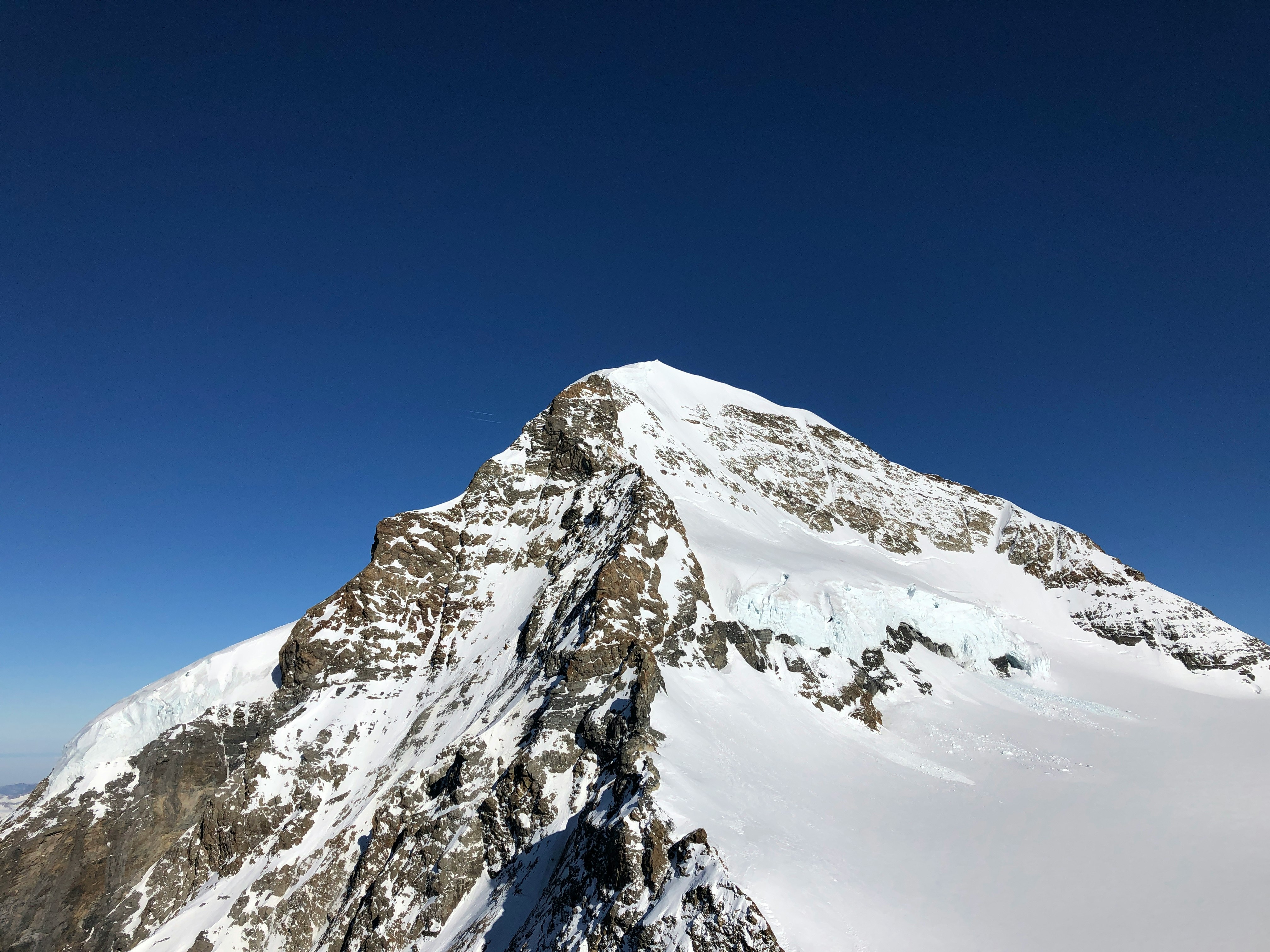 snow covered mountain under blue sky during daytime